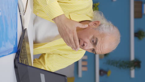 Vertical-video-of-Home-office-worker-old-man-confused-and-thoughtful.